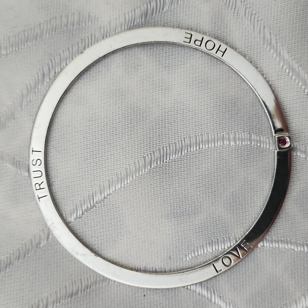 ELLE Sterling Silver "Trust Love Hope" Bangle with ruby accent.